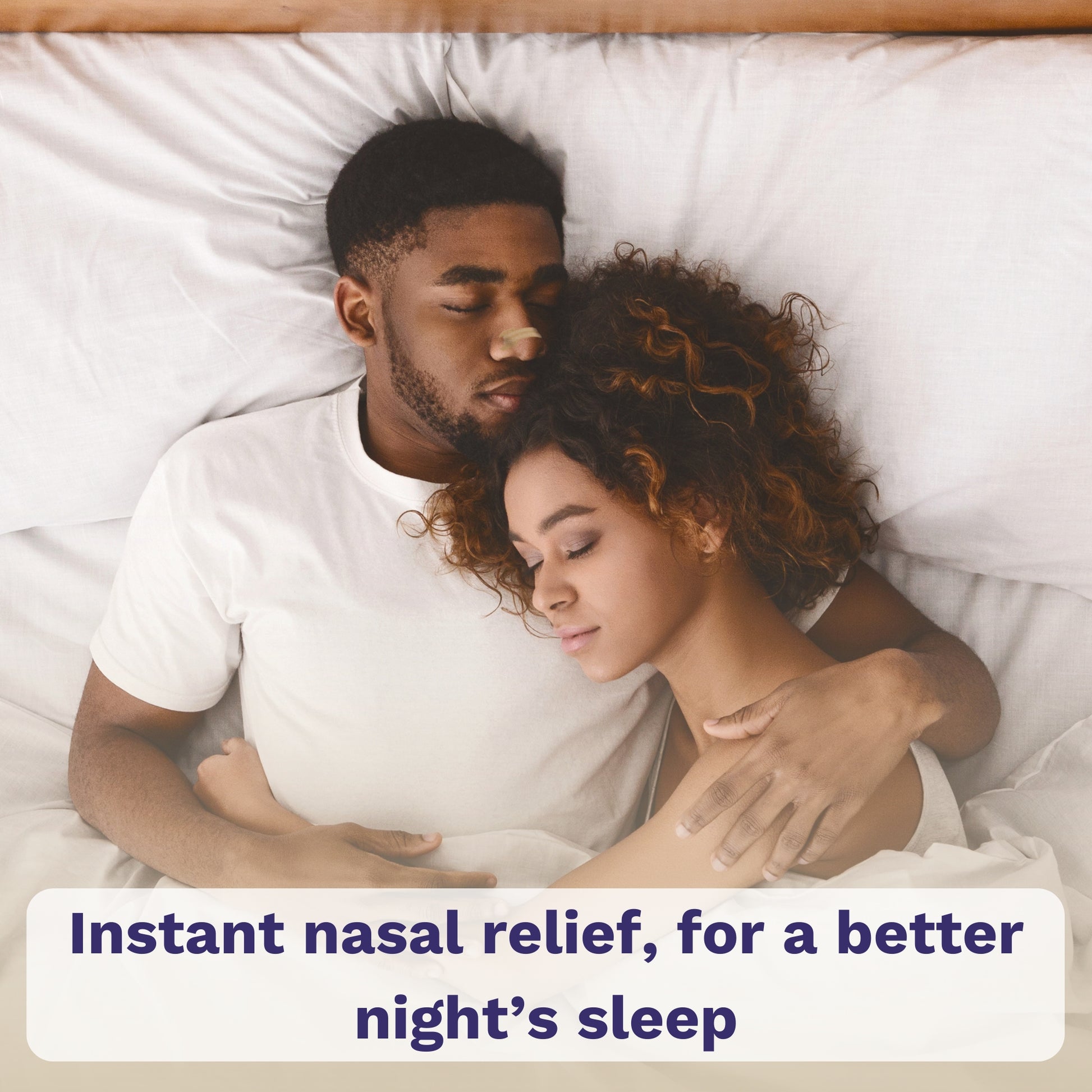 Couple sleeping in bed; man wearing beige nasal strip.